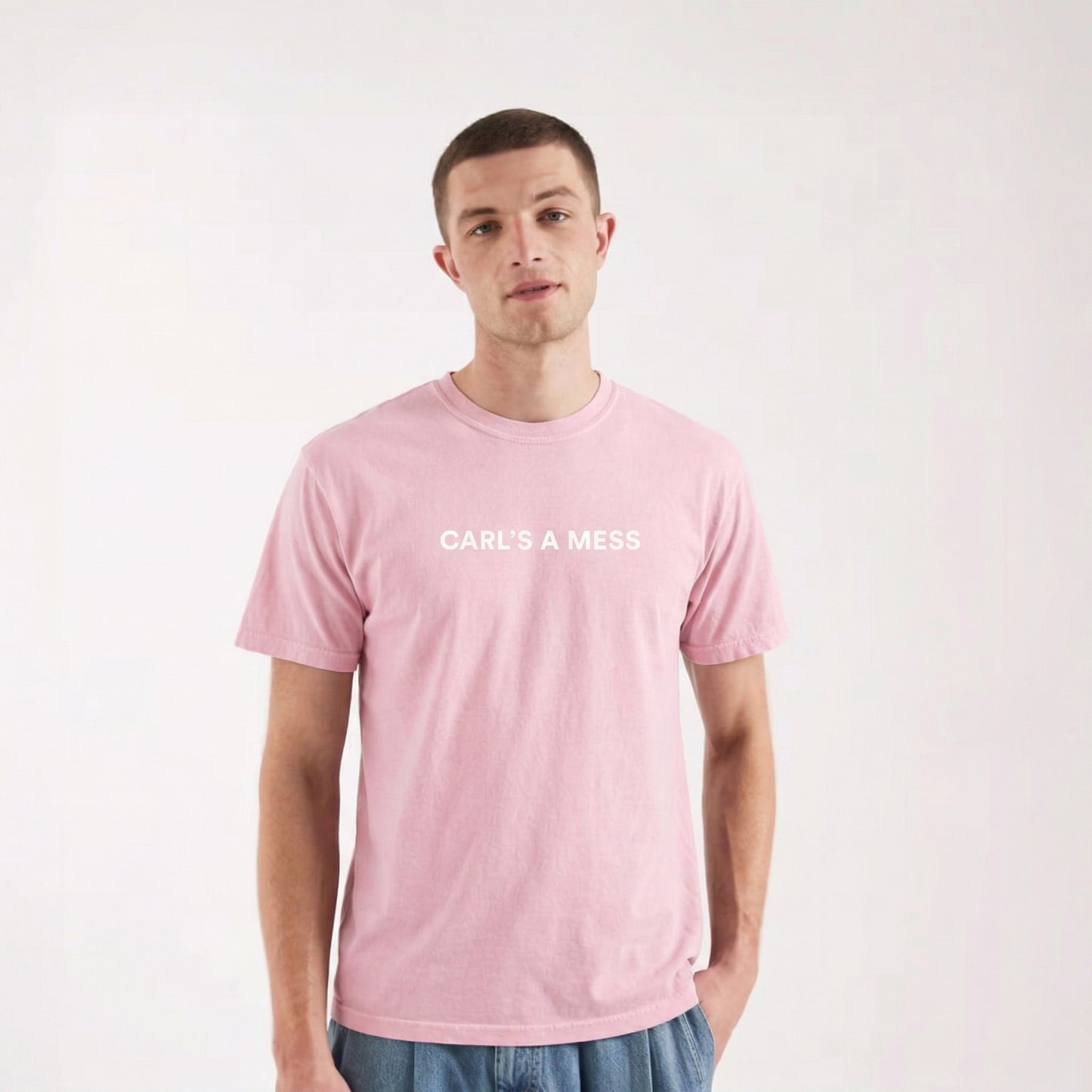 Person wearing a pink t-shirt with 'CARLS A MESS' text on a white background