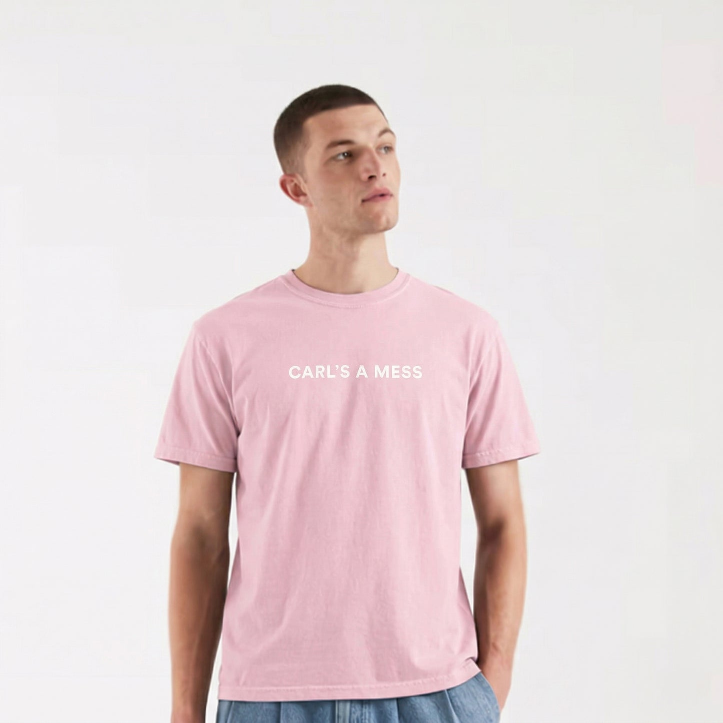 Person wearing a pink t-shirt with 'CARL'S A MESS' text on a white background