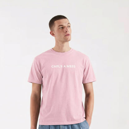 Person wearing a pink t-shirt with 'CARL'S A MESS' text on a white background