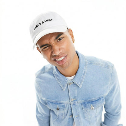 Person wearing a white cap with text and a denim jacket on a white background