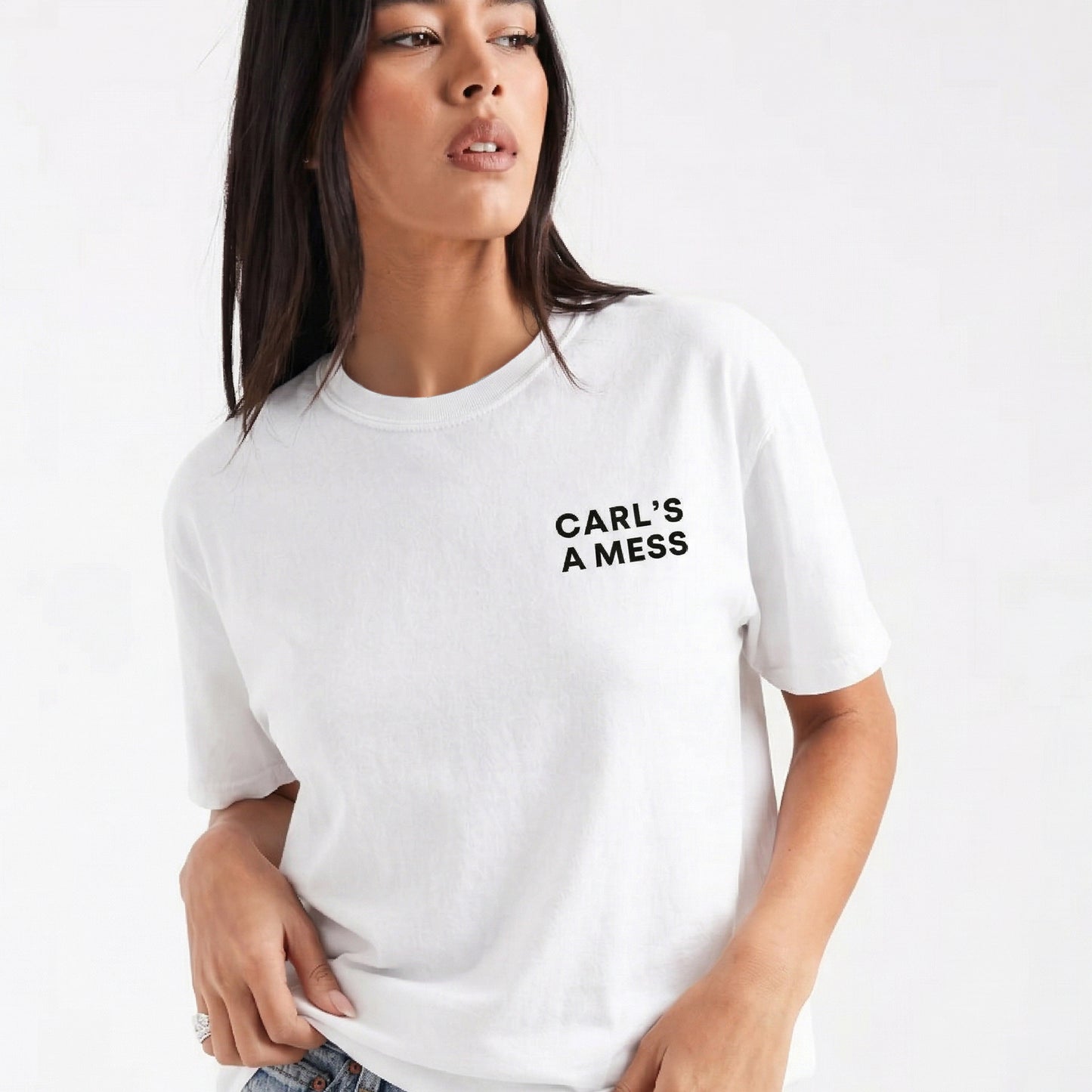 Woman wearing a white t-shirt with 'CARL'S A MESS' text on a plain background